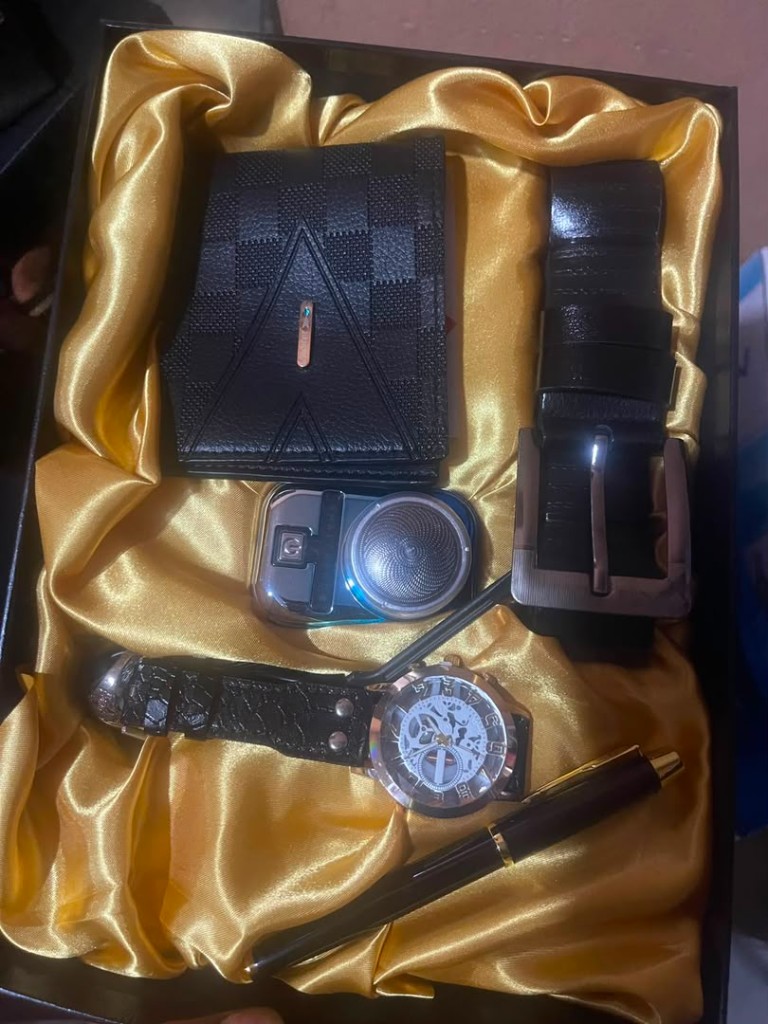 Gold executive gift set with wallet, belt, shaver, watch, and pen